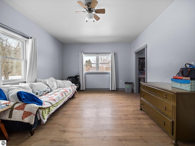 bedroom with ceiling fan and light wood-style flooring