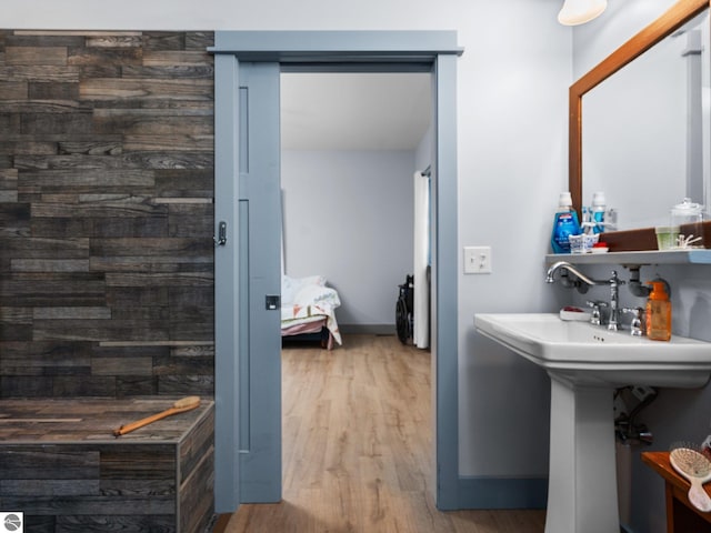 bathroom featuring wood finished floors and baseboards