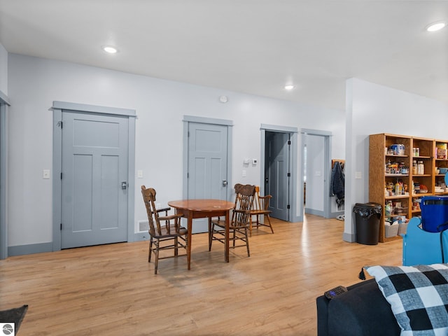dining space featuring baseboards, light wood-style flooring, and recessed lighting