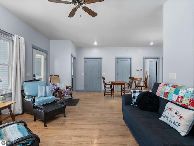 living room featuring a ceiling fan, recessed lighting, and light wood finished floors