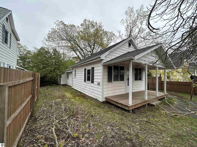 425 Barlow St, Traverse City, MI 49686 - view of home's exterior with a fenced backyard and a shingled roof