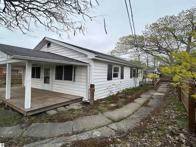 425 Barlow St, Traverse City, MI 49686 - view of side of home with a deck and a shingled roof