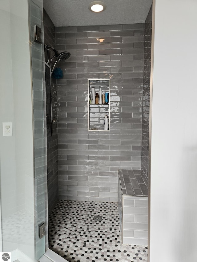 bathroom with a shower stall