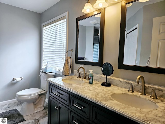 full bathroom featuring marble finish floor, a sink, toilet, and double vanity