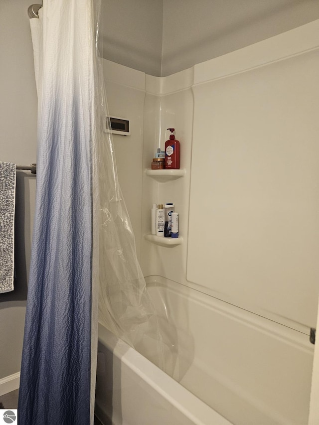 full bath featuring shower / tub combo with curtain