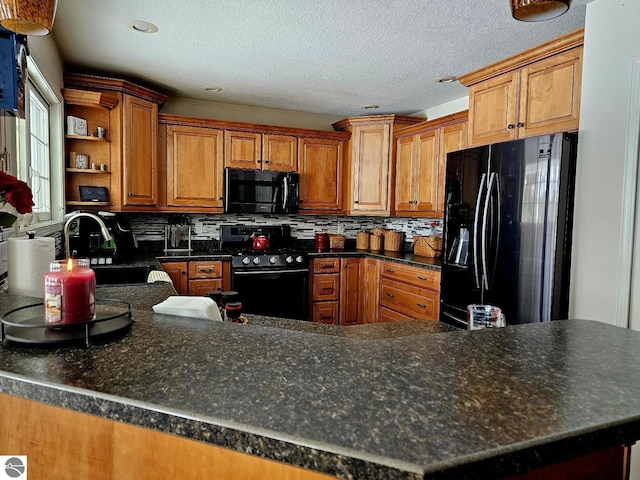 kitchen featuring tasteful backsplash, brown cabinets, black appliances, open shelves, and a sink