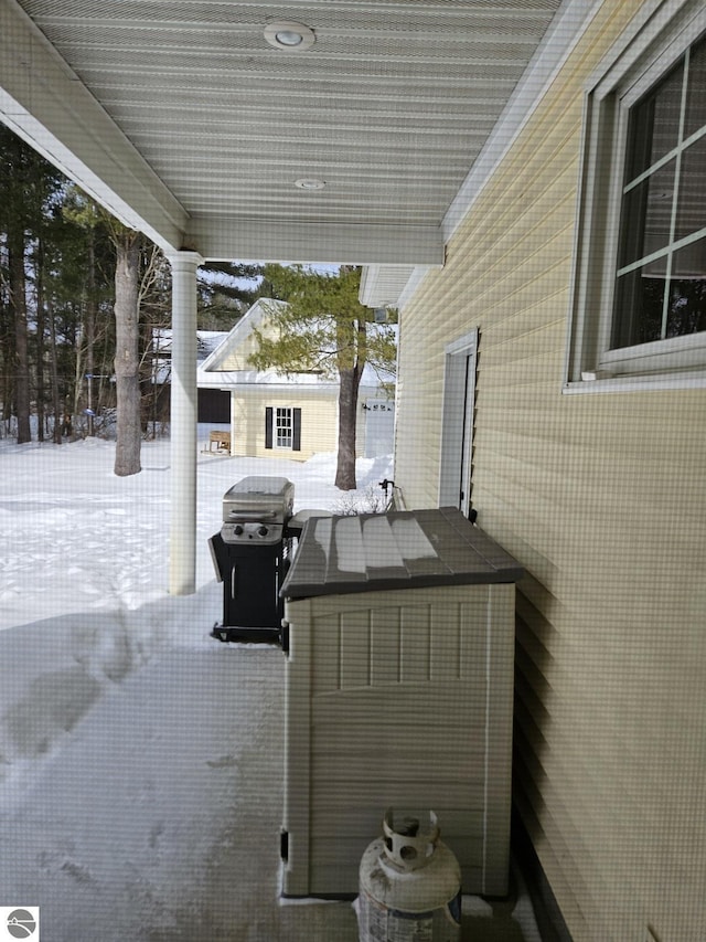 snow covered patio with grilling area