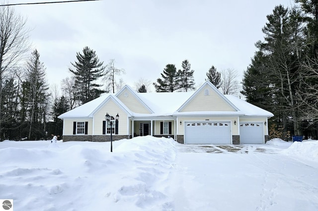 view of front of home with stone siding and an attached garage