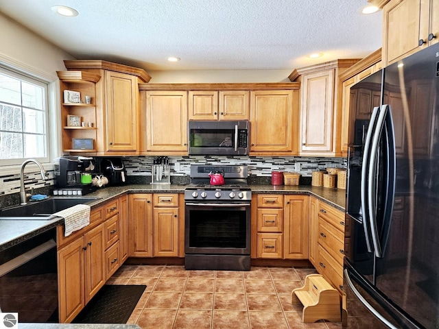 kitchen with black appliances, light tile patterned floors, decorative backsplash, and a sink