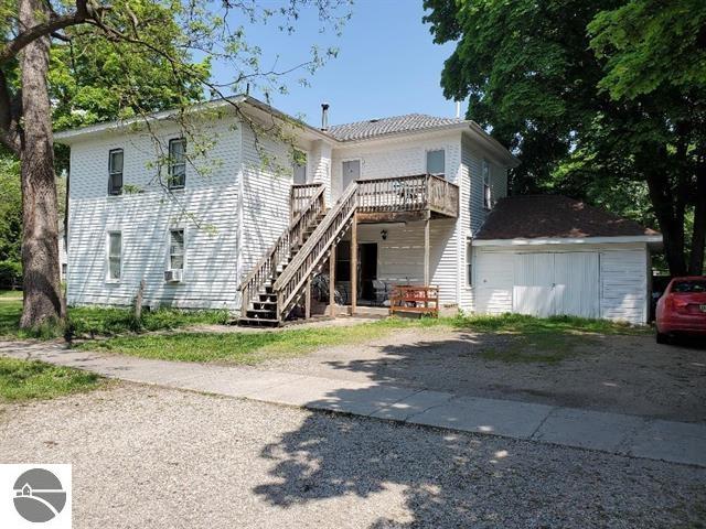221 W Locust, Mount Pleasant, MI 48858 - rear view of house featuring stairway, a deck, driveway, and cooling unit