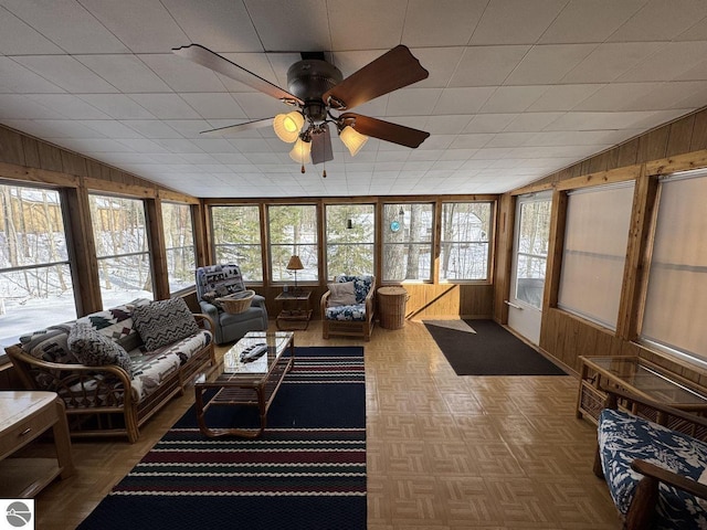 sunroom / solarium featuring a ceiling fan and lofted ceiling