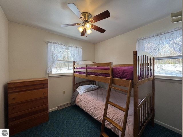 bedroom with a baseboard heating unit, ceiling fan, carpet flooring, and baseboards