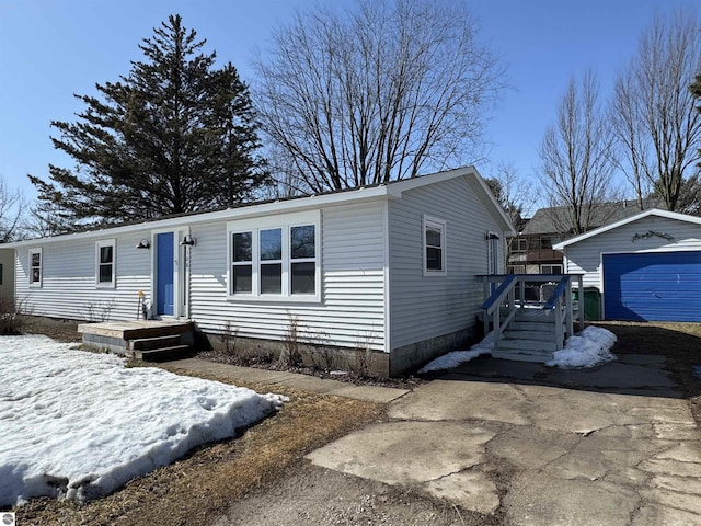 manufactured / mobile home with a garage and an outdoor structure