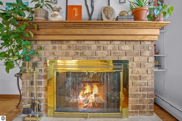 details with a baseboard radiator, a fireplace, and baseboards