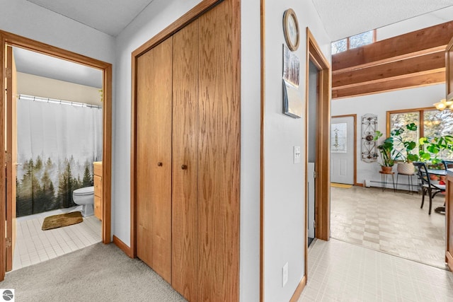 hallway featuring a baseboard radiator and a chandelier