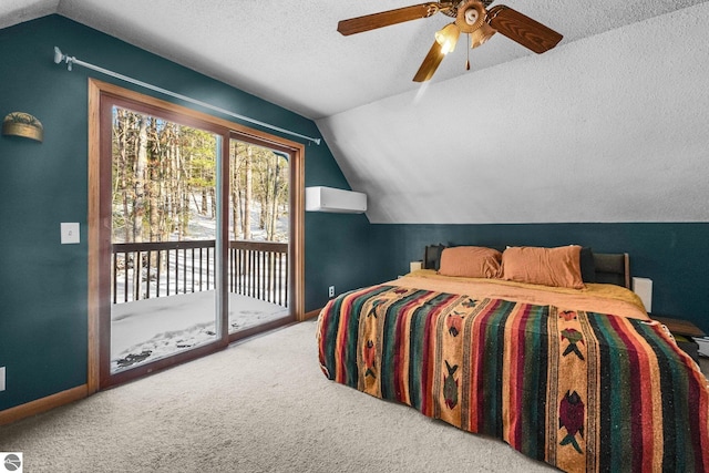 bedroom with access to exterior, vaulted ceiling, carpet floors, and a textured ceiling