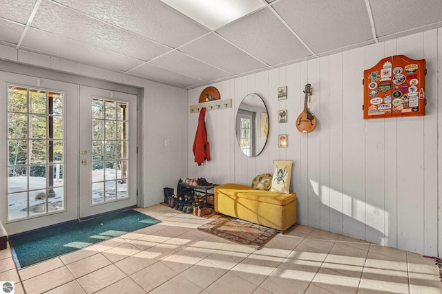 mudroom with a paneled ceiling, tile patterned flooring, and french doors