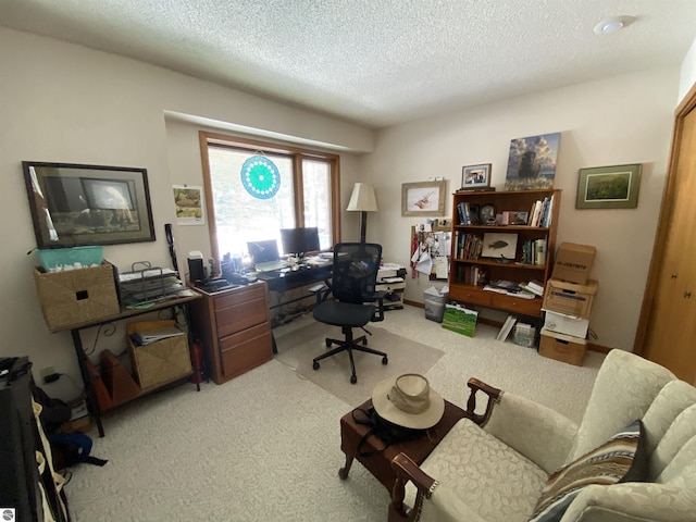 office with carpet and a textured ceiling