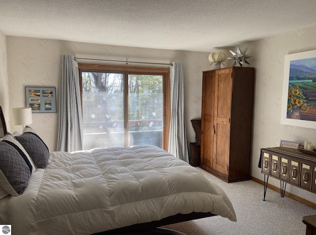 bedroom with a textured wall, baseboards, a textured ceiling, and light colored carpet