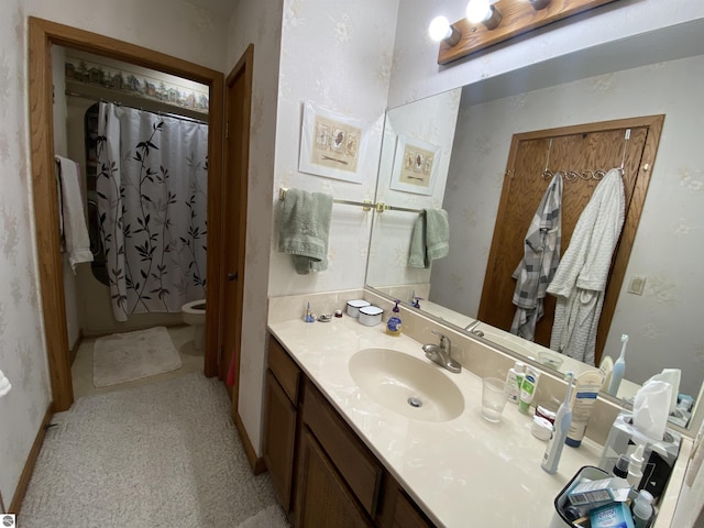 bathroom with toilet, a shower with shower curtain, and vanity