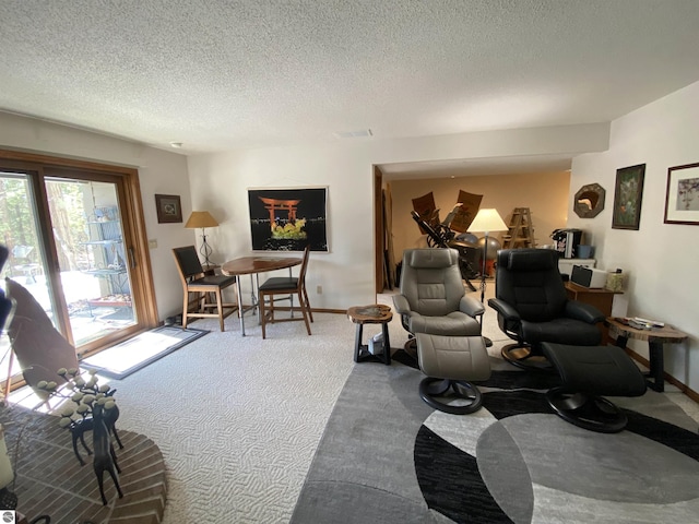 carpeted living area with a textured ceiling, visible vents, and baseboards