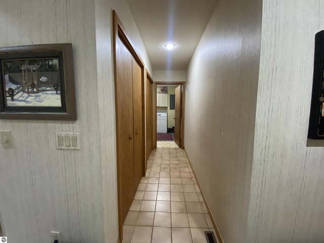 corridor featuring visible vents and light tile patterned floors