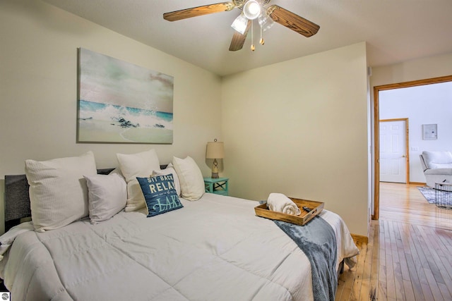 bedroom with a ceiling fan and light wood-style floors