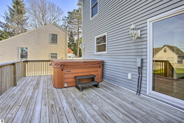 wooden terrace featuring a hot tub