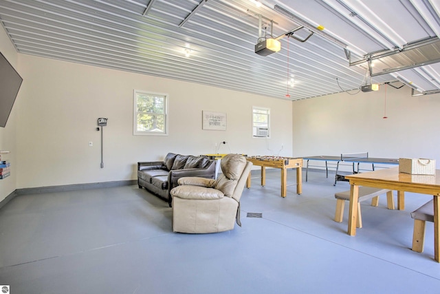 garage with cooling unit, a garage door opener, and baseboards