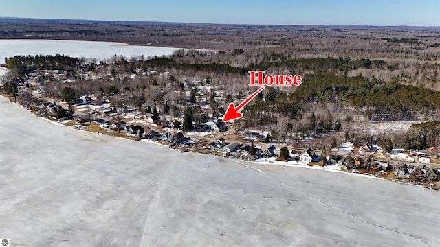 birds eye view of property featuring a wooded view and a water view