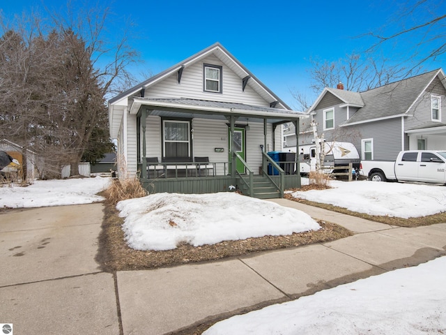 view of front of home featuring metal roof and a porch