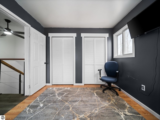 interior space with baseboards and wood finished floors