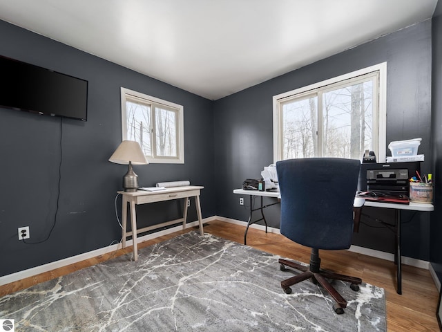 home office featuring baseboards and wood finished floors