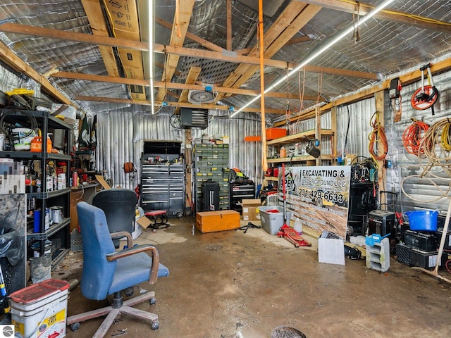 interior space featuring a workshop area and metal wall