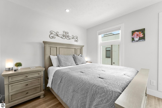 bedroom with wood finished floors and baseboards