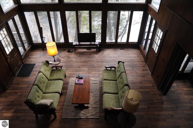 living area featuring a towering ceiling and wood finished floors