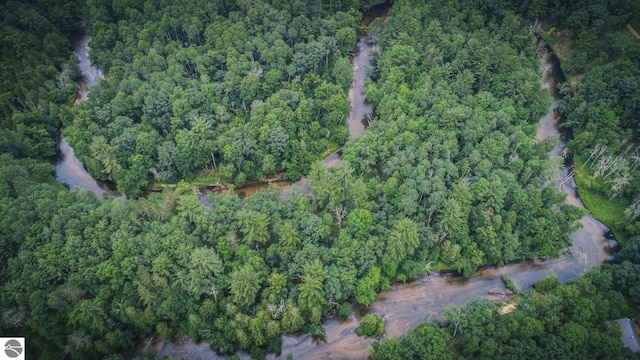 birds eye view of property with a wooded view