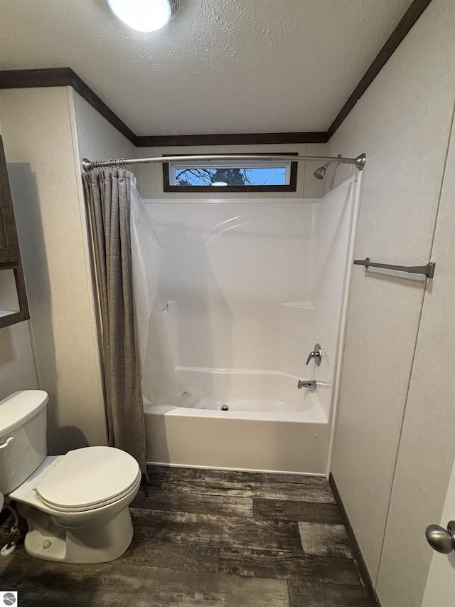 full bathroom featuring shower / tub combo with curtain, toilet, ornamental molding, a textured ceiling, and wood finished floors