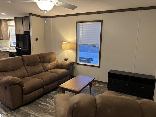 living room featuring a ceiling fan and dark wood-style flooring