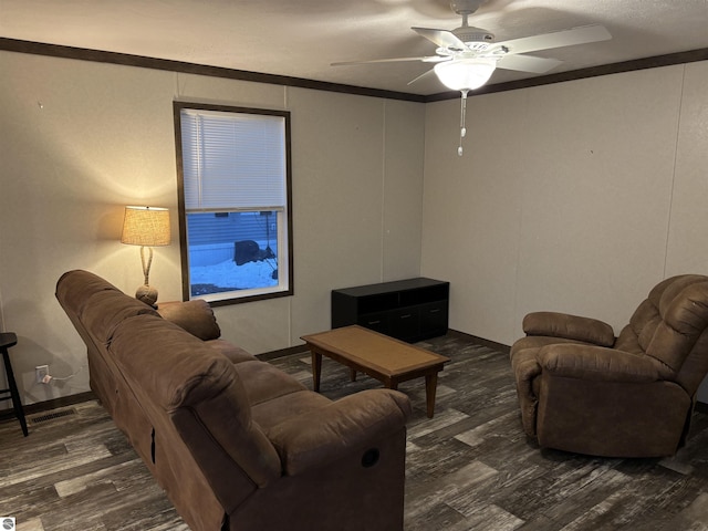 living area featuring visible vents, ornamental molding, wood finished floors, and a ceiling fan