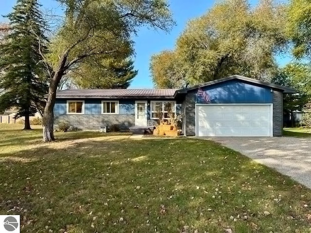 ranch-style home with an attached garage, metal roof, stone siding, driveway, and a front lawn