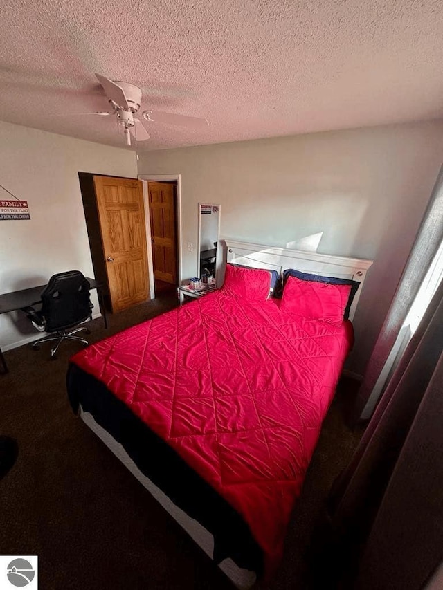 bedroom featuring baseboards, a ceiling fan, and a textured ceiling