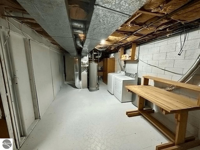 unfinished basement with heating unit, water heater, and washer and clothes dryer