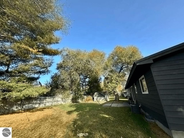 view of yard with central AC unit and a fenced backyard