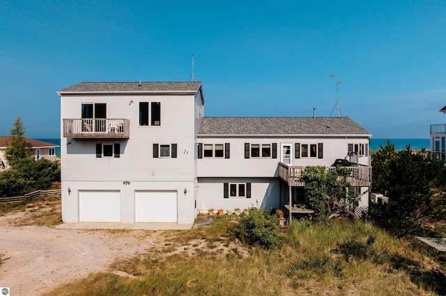 rear view of house featuring driveway and an attached garage