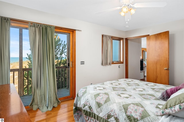 bedroom with light wood finished floors, access to outside, and ceiling fan