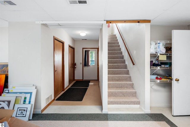 entrance foyer featuring visible vents, baseboards, and stairs