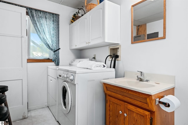 laundry area featuring a sink, light tile patterned floors, cabinet space, and washer and dryer