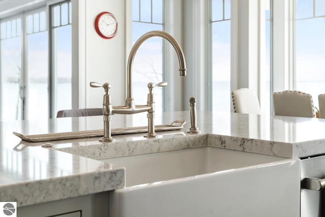 room details with a sink and light stone counters