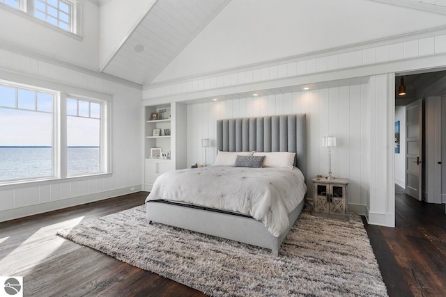 bedroom with baseboards, high vaulted ceiling, wood finished floors, and a water view